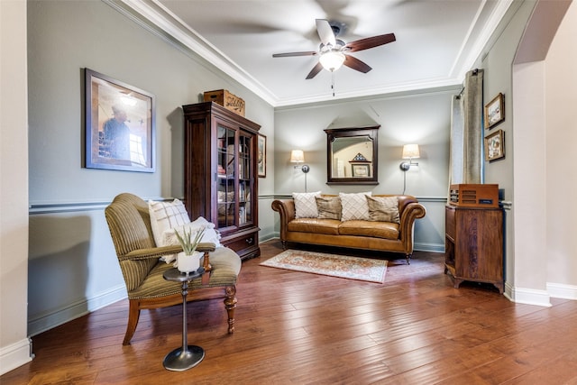 sitting room featuring baseboards, ornamental molding, ceiling fan, and hardwood / wood-style floors