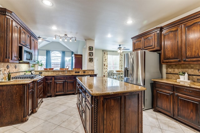 kitchen with ceiling fan, stainless steel appliances, plenty of natural light, and a sink