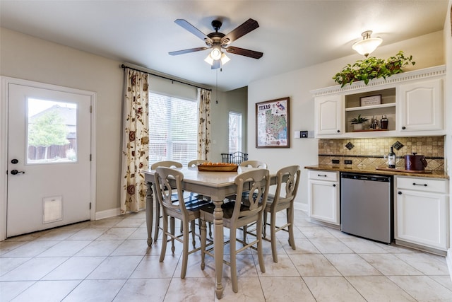 dining area with light tile patterned floors, baseboards, and a ceiling fan