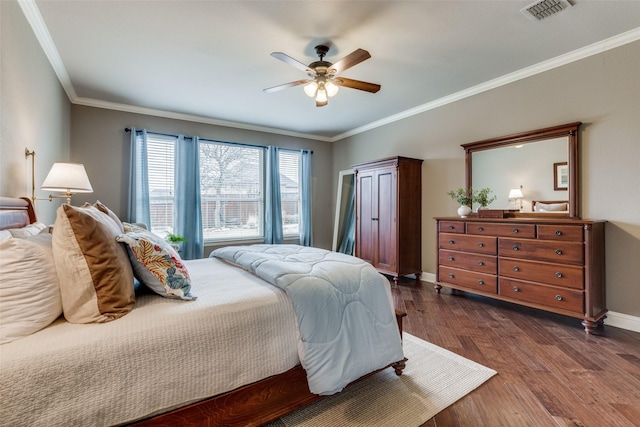 bedroom with baseboards, visible vents, dark wood-type flooring, and ornamental molding