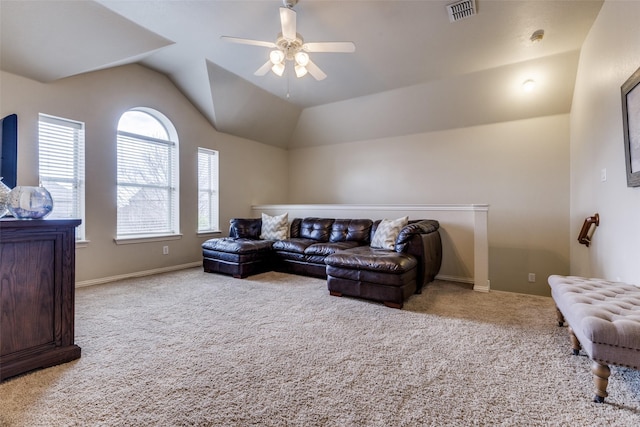 carpeted living room with lofted ceiling, plenty of natural light, visible vents, and baseboards