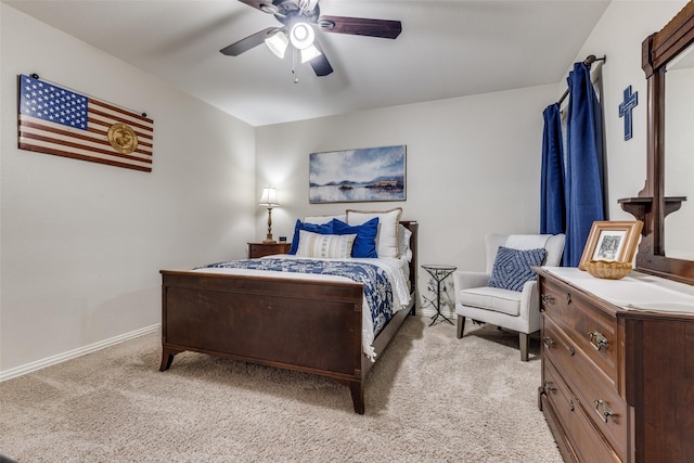 bedroom featuring a ceiling fan, light colored carpet, and baseboards