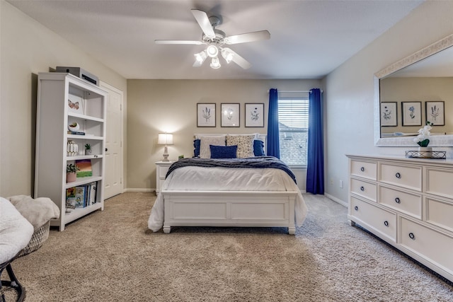 bedroom featuring light carpet, ceiling fan, and baseboards