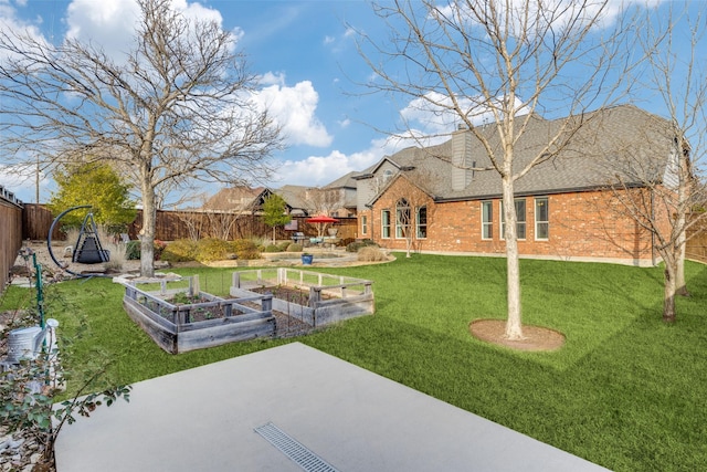 view of yard featuring a fenced backyard and a vegetable garden