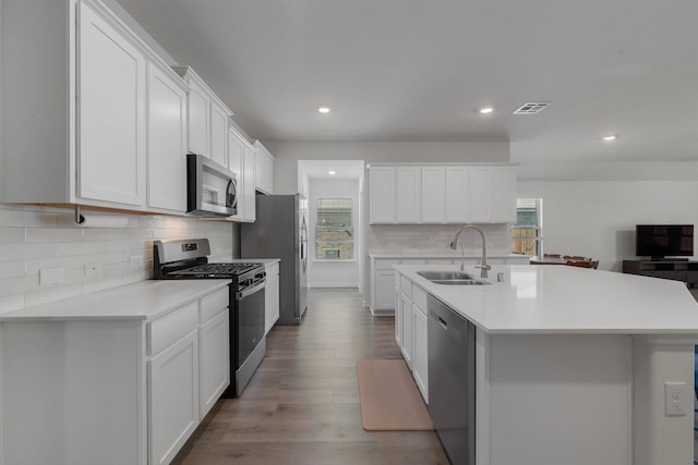 kitchen with stainless steel appliances, light countertops, a healthy amount of sunlight, and a sink