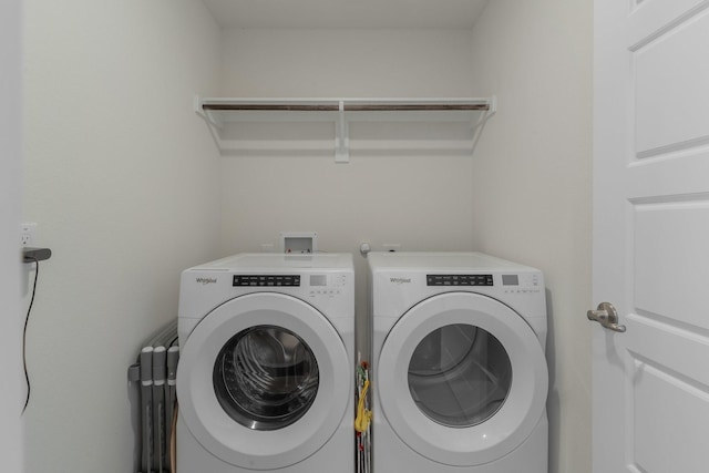 clothes washing area featuring laundry area and washer and dryer