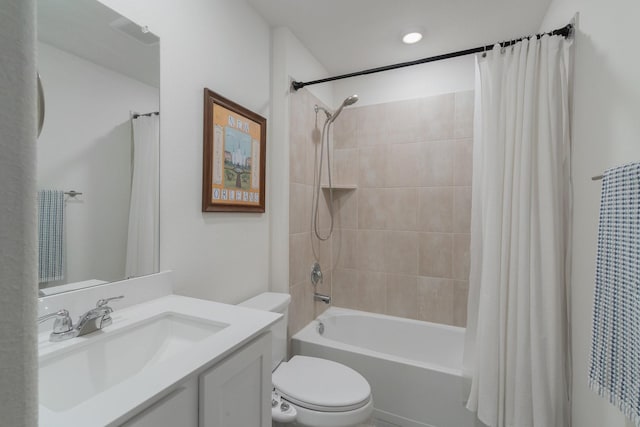 bathroom featuring toilet, shower / bathtub combination with curtain, and vanity