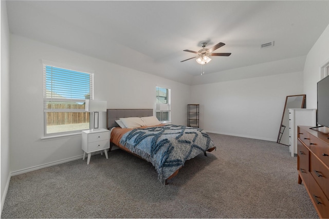 carpeted bedroom with a ceiling fan, visible vents, and baseboards