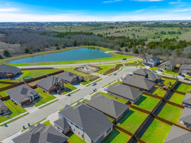 drone / aerial view with a residential view and a water view