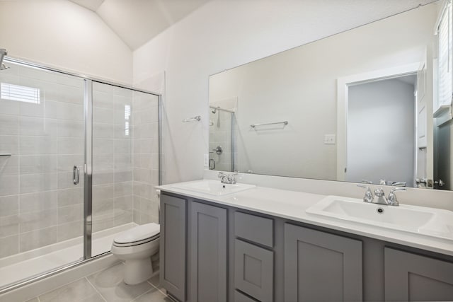 full bathroom featuring toilet, a shower stall, double vanity, and a sink