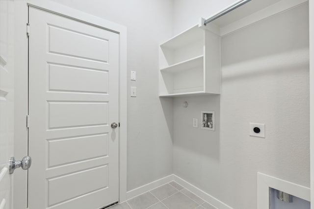 laundry area featuring laundry area, baseboards, tile patterned flooring, hookup for an electric dryer, and washer hookup