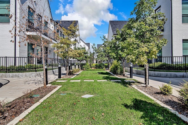 surrounding community featuring fence and a lawn