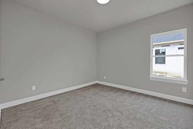 empty room with carpet floors and baseboards