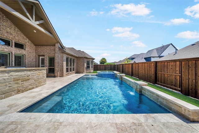 view of pool featuring a patio area, a fenced backyard, and a pool with connected hot tub