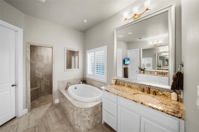 full bath featuring a garden tub, visible vents, walk in shower, and vanity