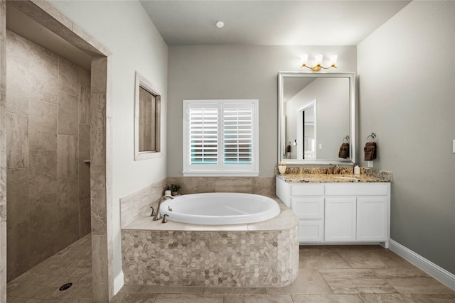 bathroom with a tile shower, vanity, and a bath