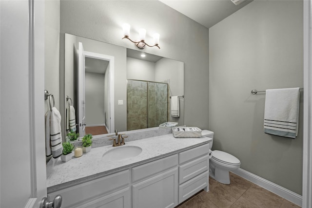 full bathroom with toilet, a tile shower, vanity, tile patterned flooring, and baseboards