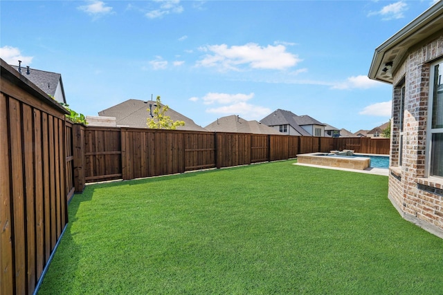 view of yard featuring a fenced backyard and a pool with connected hot tub