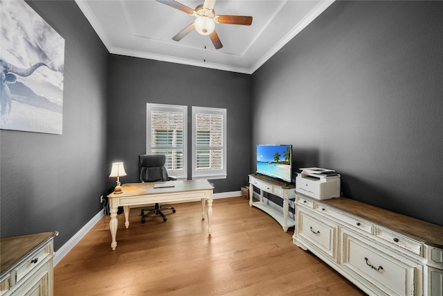 office area with light wood-style floors, crown molding, baseboards, and a ceiling fan