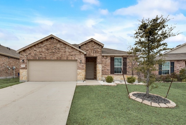 single story home featuring a front yard, concrete driveway, brick siding, and an attached garage