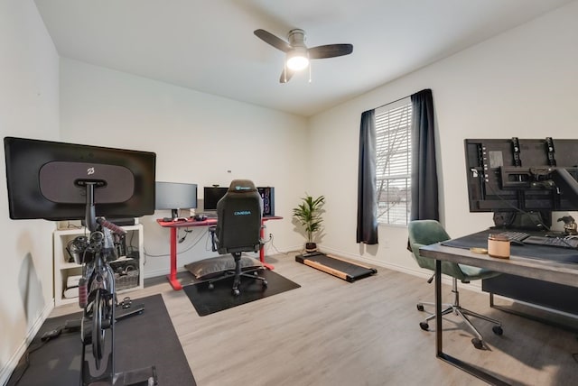 office area with baseboards, a ceiling fan, and wood finished floors