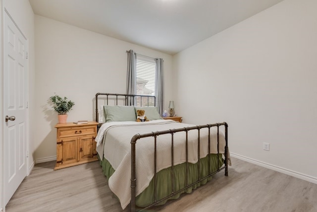 bedroom with baseboards and light wood-style floors