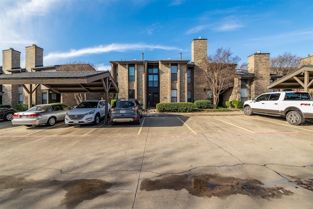 view of property with covered and uncovered parking