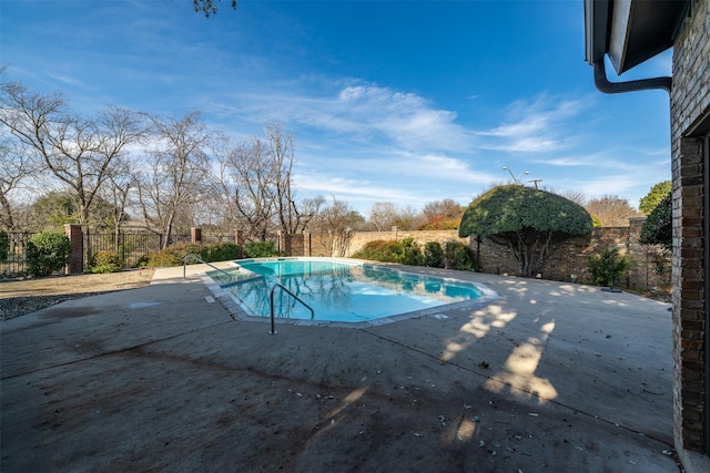 view of swimming pool featuring a patio area, a fenced backyard, and a fenced in pool