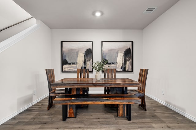 dining space featuring visible vents, baseboards, and wood finished floors