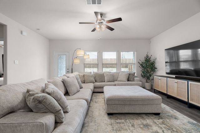 living room with visible vents, a ceiling fan, and wood finished floors