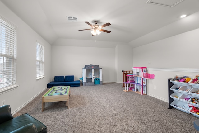 recreation room with lofted ceiling, a ceiling fan, visible vents, and carpet flooring