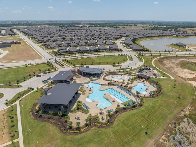 drone / aerial view featuring a water view and a residential view