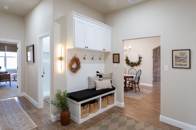 mudroom with wood finished floors and baseboards