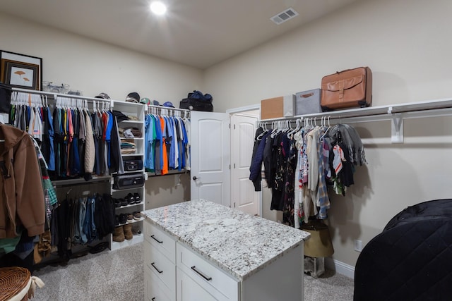 walk in closet featuring light colored carpet and visible vents