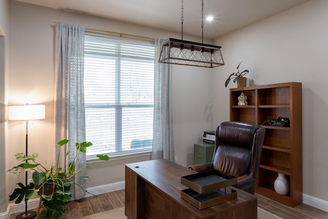 office area featuring baseboards and wood finish floors