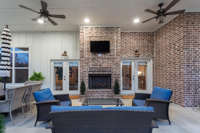 view of patio with a ceiling fan, french doors, and an outdoor living space with a fireplace