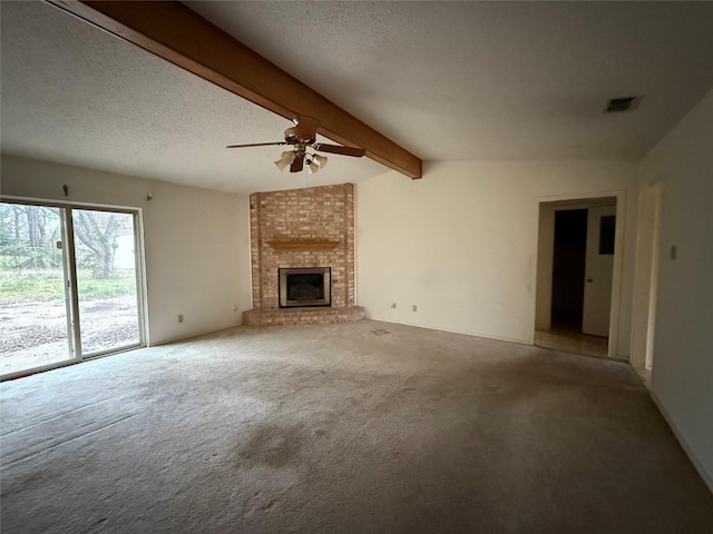 unfurnished living room featuring vaulted ceiling with beams, visible vents, a brick fireplace, carpet flooring, and a textured ceiling