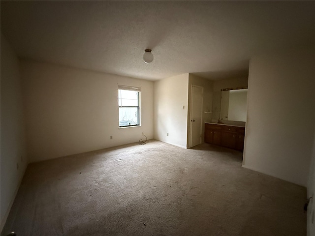 unfurnished bedroom with a textured ceiling and carpet flooring