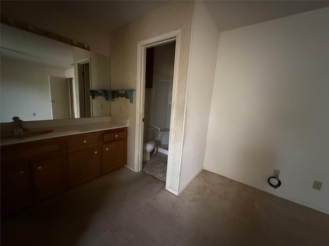 bathroom featuring a shower, vanity, and toilet