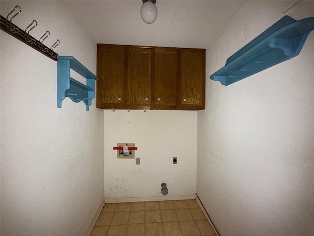 laundry room featuring hookup for a washing machine, cabinet space, electric dryer hookup, and baseboards