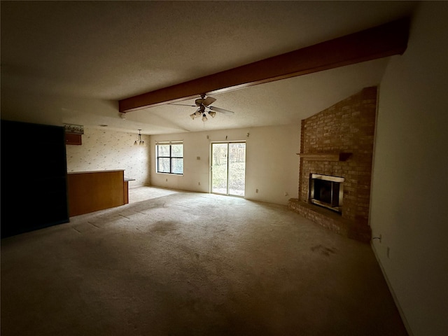 unfurnished living room with a textured ceiling, vaulted ceiling with beams, light carpet, a fireplace, and a ceiling fan