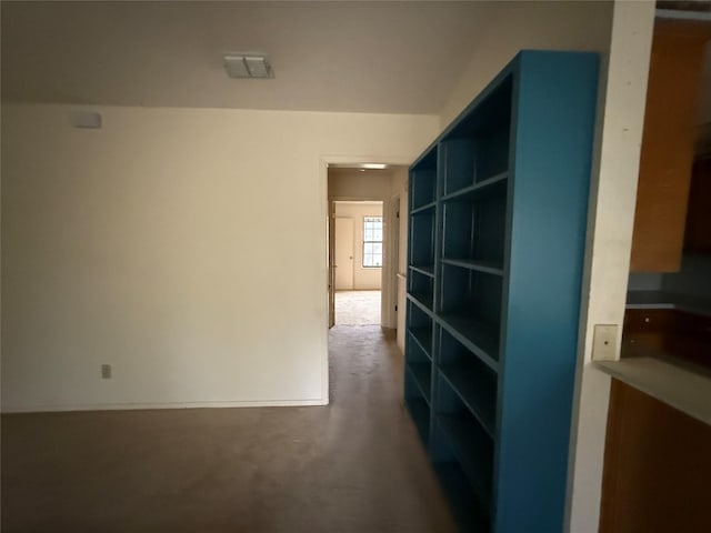 corridor featuring concrete flooring and visible vents