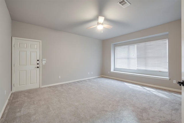 unfurnished room featuring carpet, visible vents, ceiling fan, and baseboards