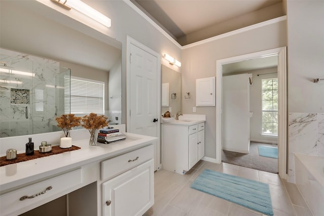 full bath featuring a marble finish shower, a bath, and vanity