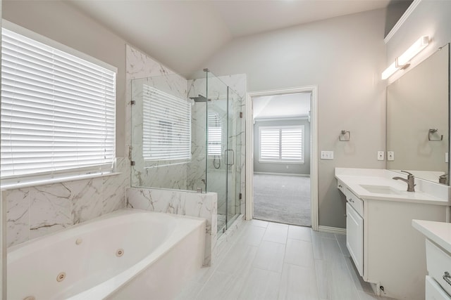 full bath featuring a marble finish shower, baseboards, a whirlpool tub, vaulted ceiling, and vanity