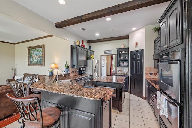 kitchen with beam ceiling, stainless steel appliances, visible vents, a sink, and a peninsula