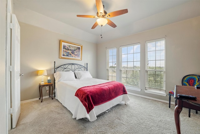 bedroom with baseboards, ceiling fan, and light colored carpet