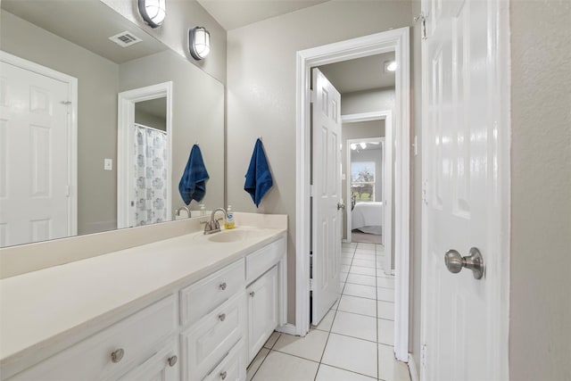 bathroom with tile patterned flooring, visible vents, and vanity