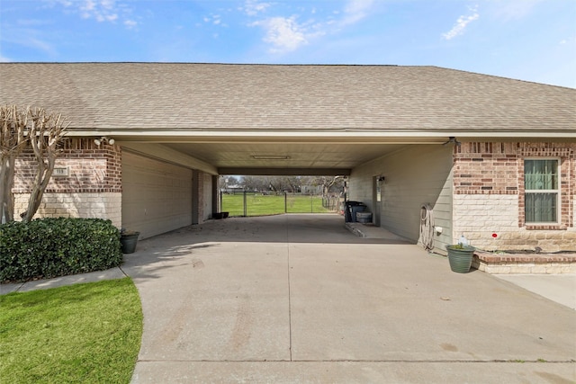 view of vehicle parking featuring a garage, an attached carport, and driveway