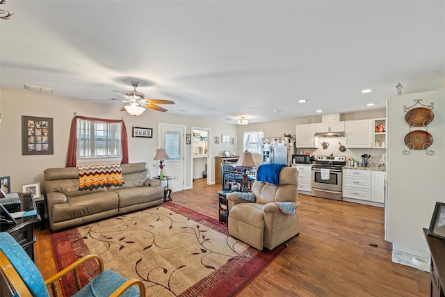 living area featuring recessed lighting, visible vents, a wealth of natural light, and wood finished floors